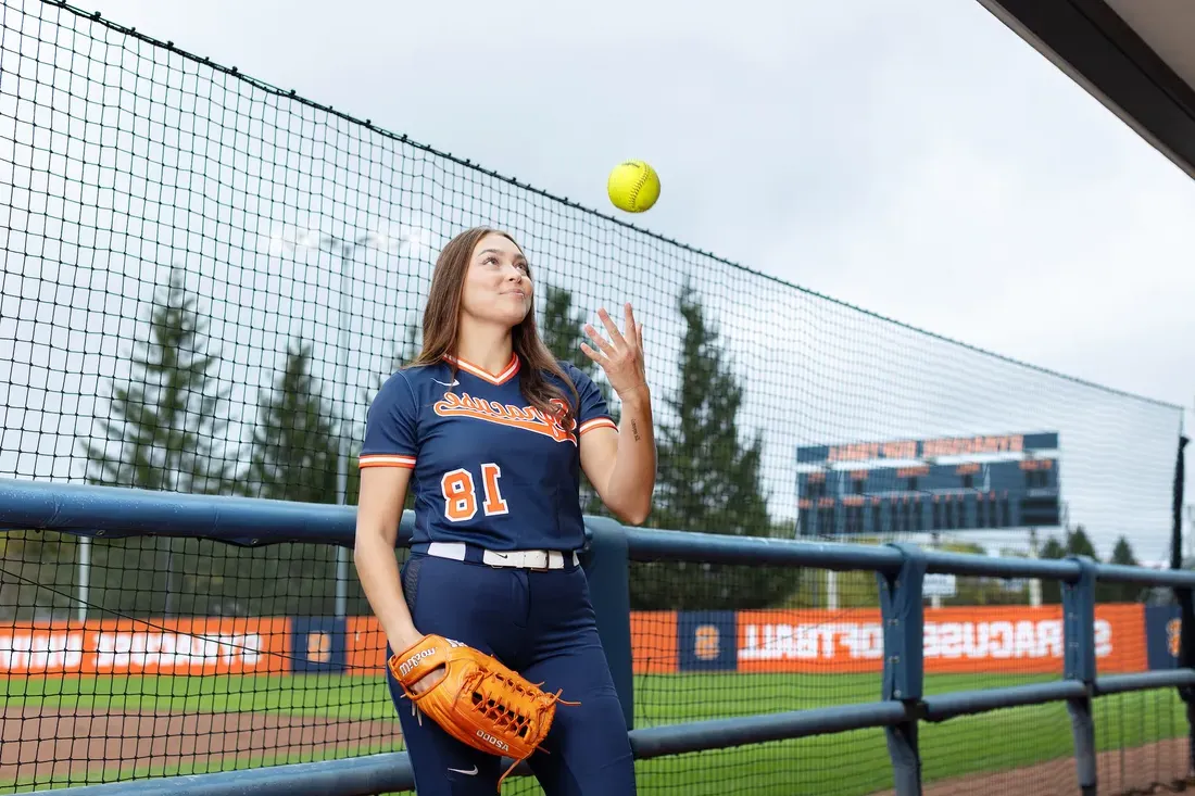 Olivia Pess throwing a softball.